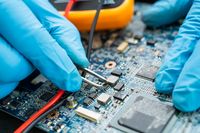 vecteezy_technician-repairing-inside-of-hard-disk_3168907